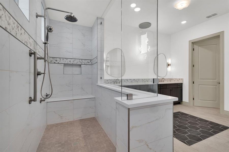 Full bath with vanity, a marble finish shower, and recessed lighting