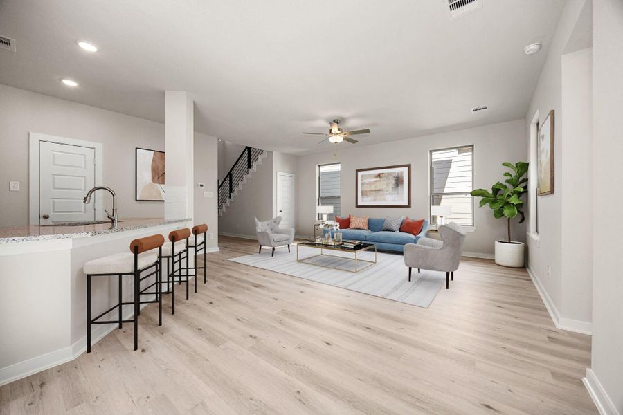 An open floor plan perfect for entertaining and daily life! The functional kitchen island offers a sleek breakfast bar for additional seating while the inviting Living Room is highlighted by a contemporary ceiling fan and large windows ensuring a bright, welcoming atmosphere throughout the main living areas. *Virtually Staged An open floor plan perfect for entertaining and daily life! The functional kitchen island offers a sleek breakfast bar for additional seating while the inviting Living Room is highlighted by a contemporary ceiling fan and large windows ensuring a bright, welcoming atmosphere throughout the main living areas. *Virtually Staged