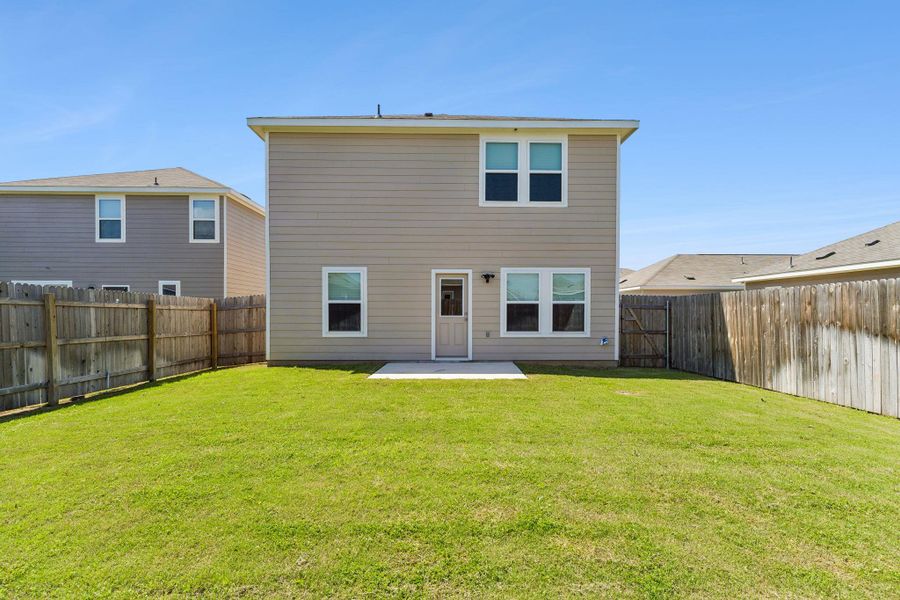 Rear view of property with a patio and a fenced backyard