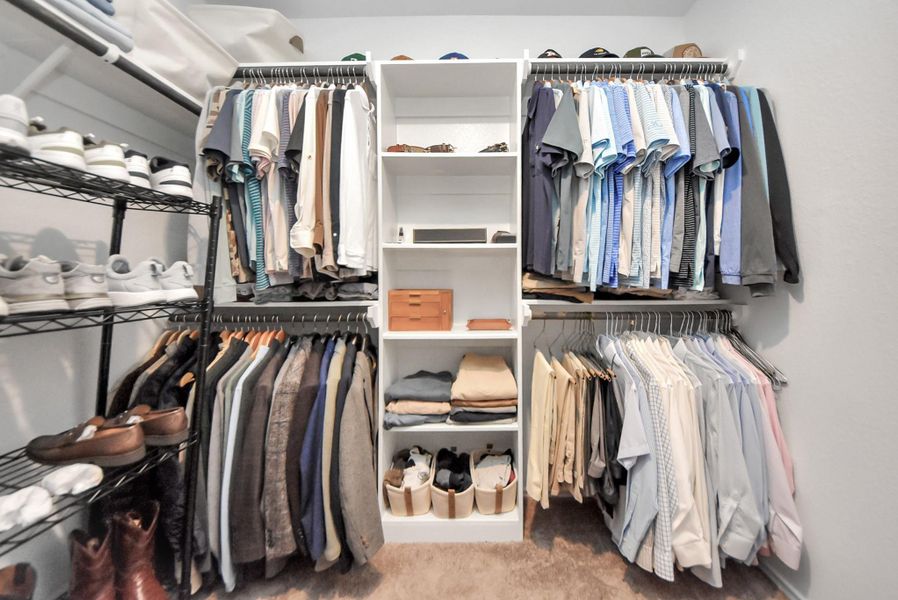 Another view of this great walk-in primary closet. Note the ample amount of hanging space and built-in shelving too. Such a great closet! Another view of this great walk-in primary closet. Note the ample amount of hanging space and built-in shelving too. Such a great closet!