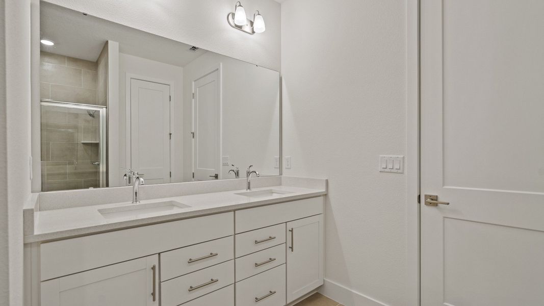 Primary En Suite Bath with dual sinks in the Buttonwood Floor Plan by DRB Homes Ardisia Park in New Smyrna Beach