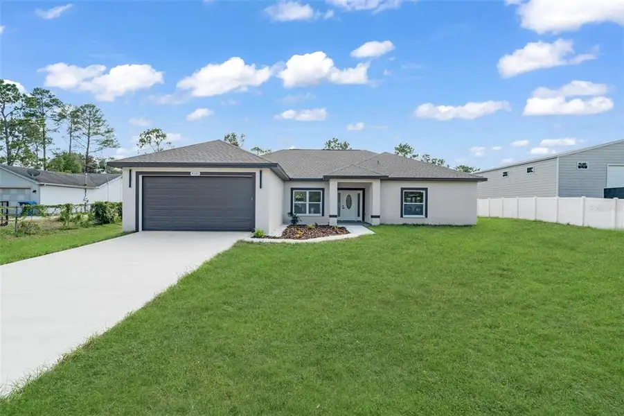 Front exterior of a new home in , Weeki Wachee, FL, highlighting curb appeal (Image 21).