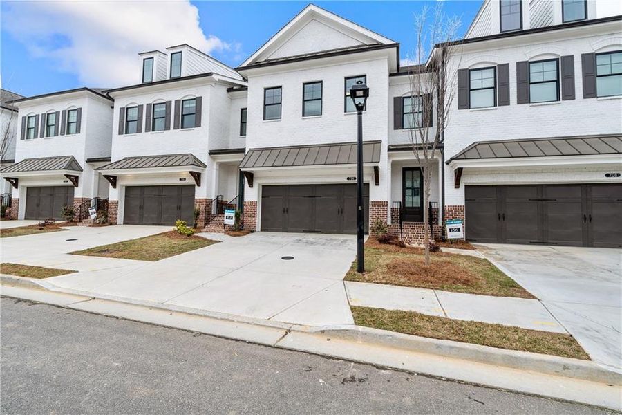Front exterior of a new home in Millcroft Townhomes, Buford, GA, highlighting curb appeal (Image 23).