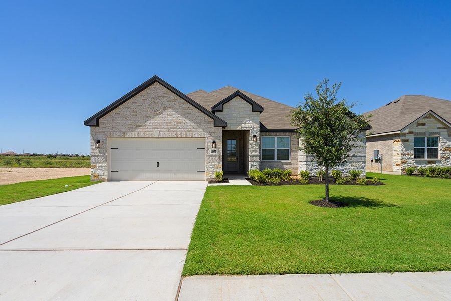 Front exterior of a new home in Canyon Ranch, Jarrell, TX, highlighting curb appeal (Image 1). Front exterior of a new home in Canyon Ranch, Jarrell, TX, highlighting curb appeal (Image 1).