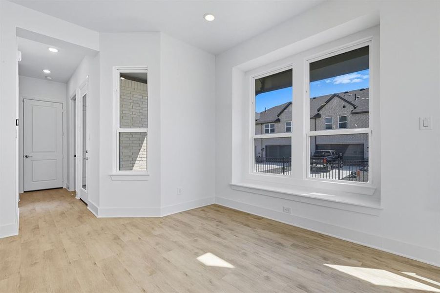 Empty room with light wood-type flooring and recessed lighting Empty room with light wood-type flooring and recessed lighting