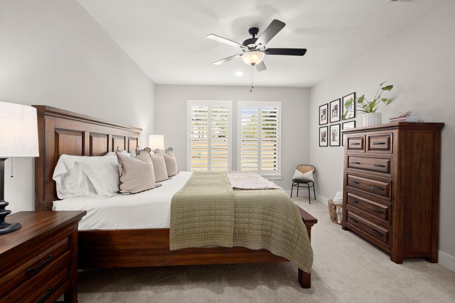 The primary bedroom enjoys an open, light-filled setting. The primary bedroom enjoys an open, light-filled setting.