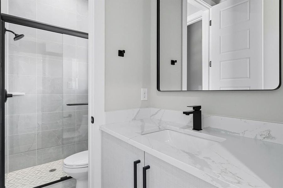 Full bathroom featuring vanity and a shower stall
