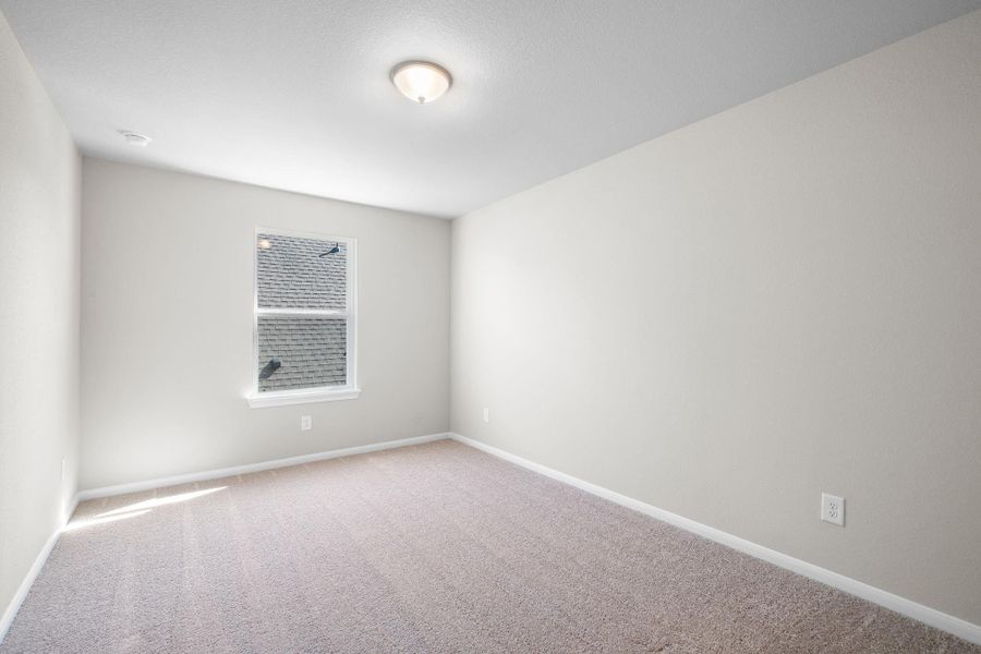 Your secondary bedroom features plush carpet, fresh paint, closet, and a large window that lets in plenty of natural lighting.