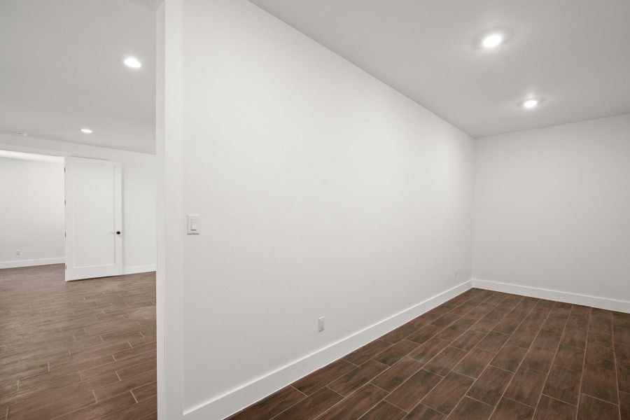 Spare room featuring recessed lighting and wood tiled floors
