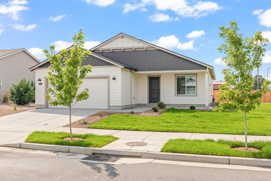 Front exterior of a new home in Willowbrook, Madras, OR, highlighting curb appeal (Image 1). Front exterior of a new home in Willowbrook, Madras, OR, highlighting curb appeal (Image 1).