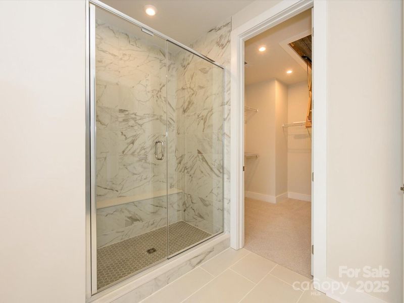 Marble-Look Tile Design at Primary Walk-In Shower.