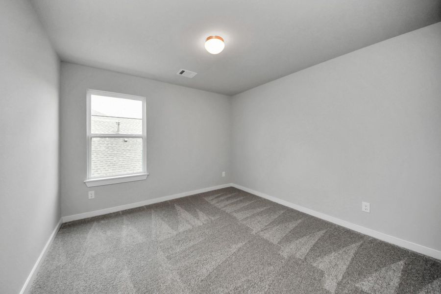 Secondary bedroom features plush carpeting, large windows that let in plenty of natural light, bright paint, and spacious closets. Secondary bedroom features plush carpeting, large windows that let in plenty of natural light, bright paint, and spacious closets.