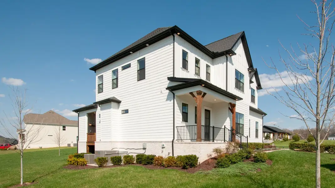 Side Exterior of white home with front and back porches Side Exterior of white home with front and back porches