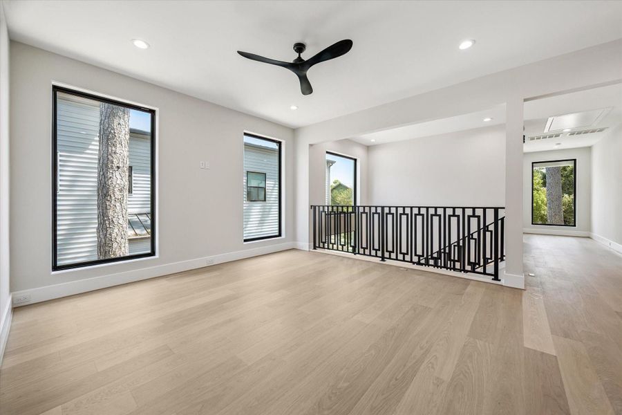 The spacious game room is finished with warm oak flooring, creating an inviting setting ideal for relaxation, play, or entertaining.