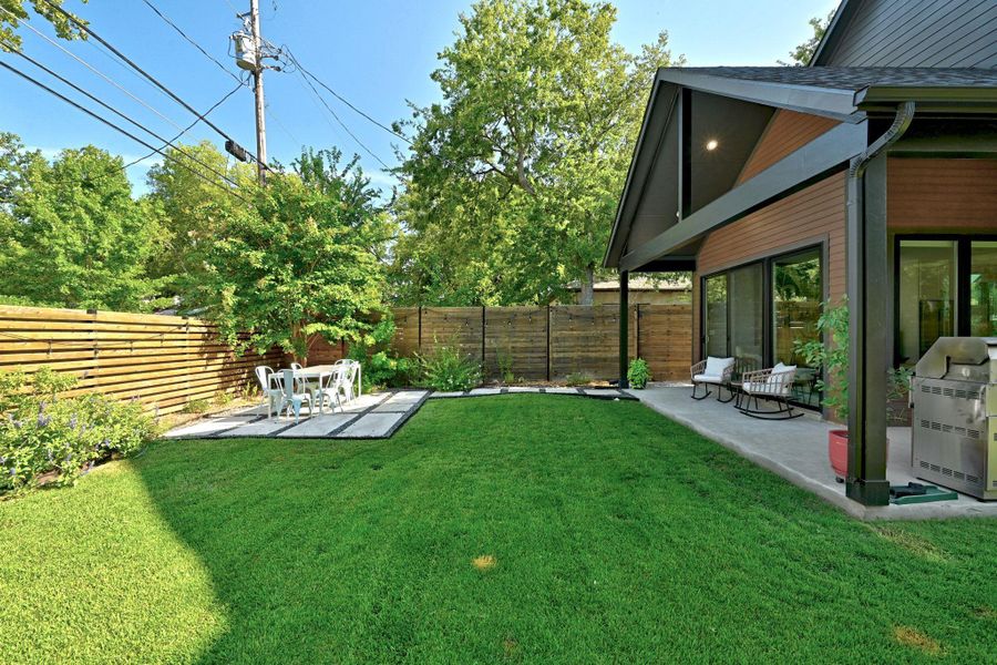 Yard view with covered and uncovered patio areas. Yard view with covered and uncovered patio areas.