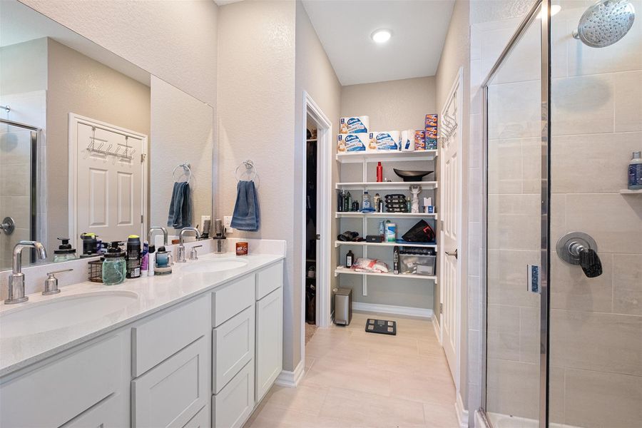 Primary bath with lots of built in storage.