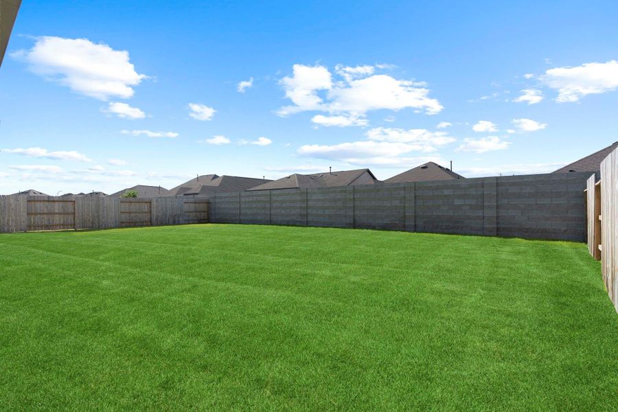 Expansive fenced backyard with plenty of green space, offering endless possibilities for play, gardening, or relaxation.  Backyard for that pool you always wanted!