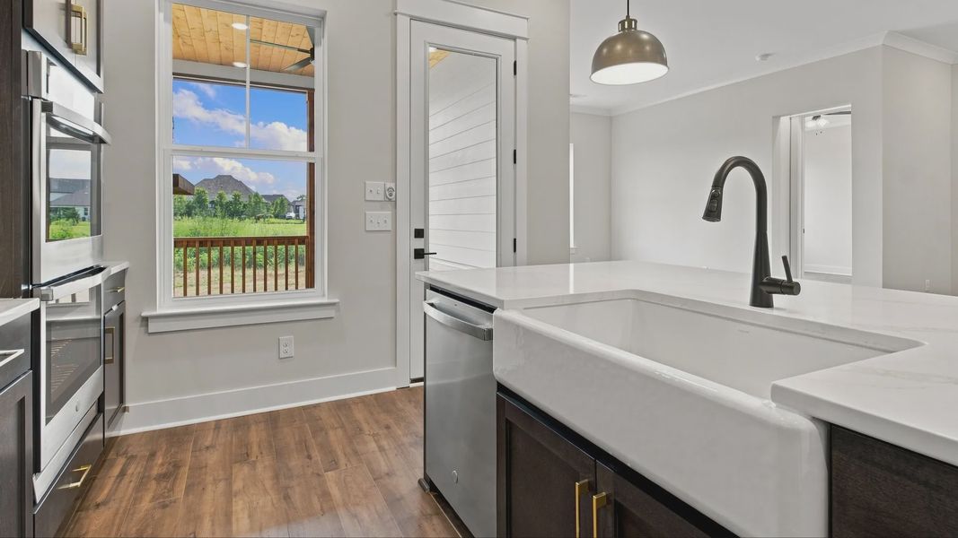 Sink and dishwasher next to backyard door.