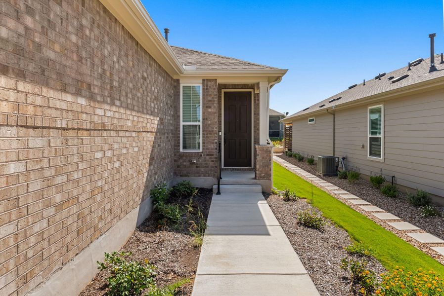 A welcoming brick exterior with a neat sidewalk leads to the inviting front entrance. A welcoming brick exterior with a neat sidewalk leads to the inviting front entrance.