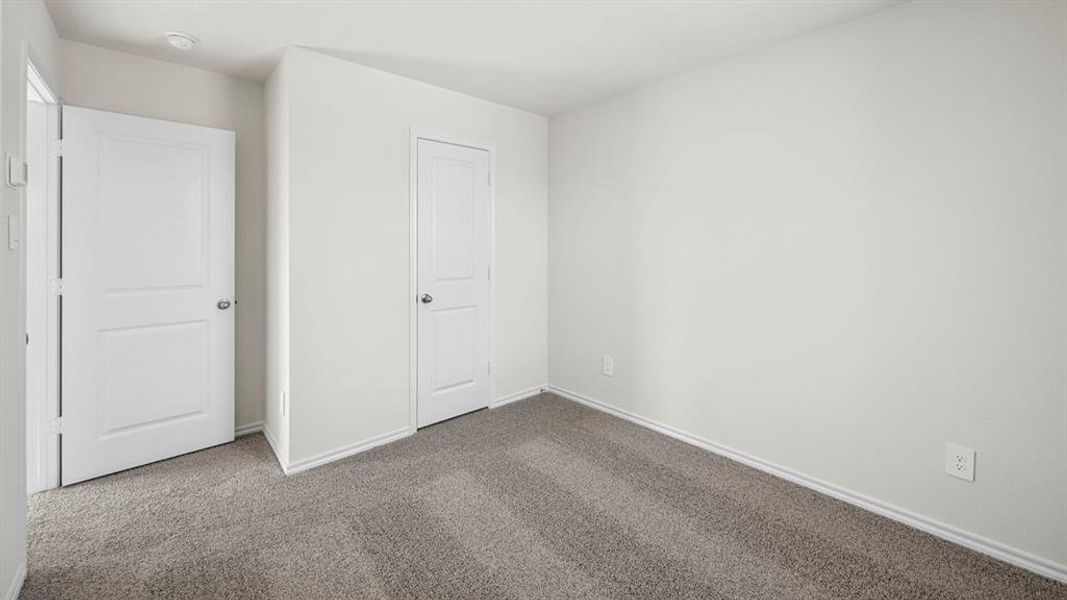 Unfurnished bedroom featuring carpet and baseboards