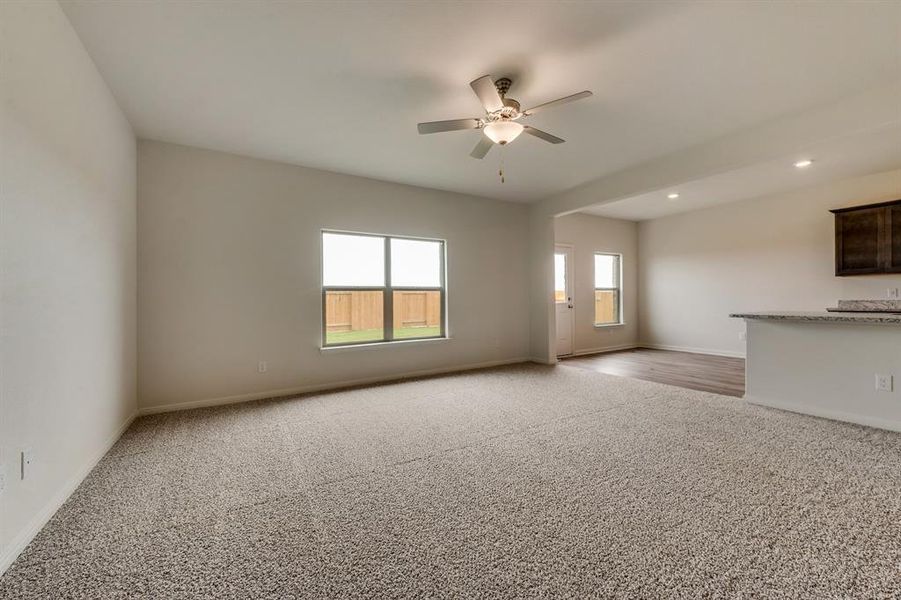 Spare room featuring ceiling fan and light colored carpet