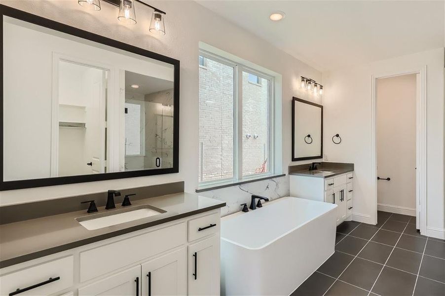 Bathroom with tile floors, separate shower and tub, and dual bowl vanity