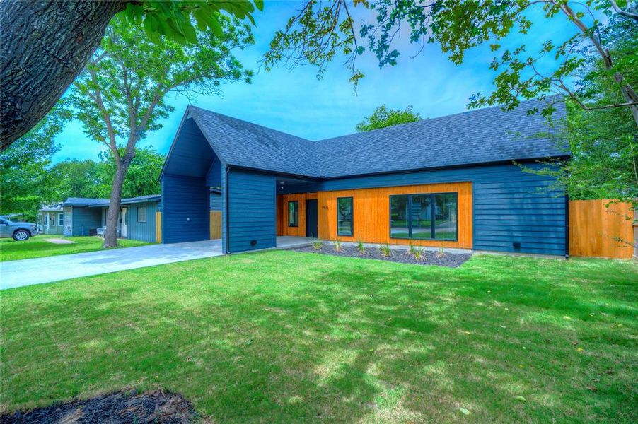 Contemporary exterior featuring dark blue siding and natural wood-tone accents