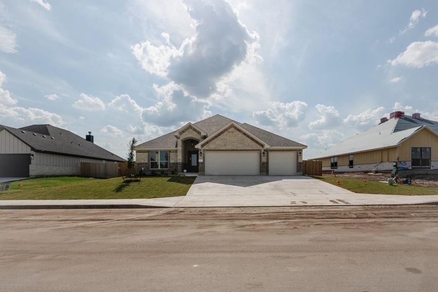 View of front of property with driveway, a garage, and brick siding View of front of property with driveway, a garage, and brick siding
