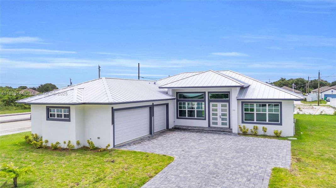 Front exterior of a new home in , Port St. Lucie, FL, highlighting curb appeal (Image 25).