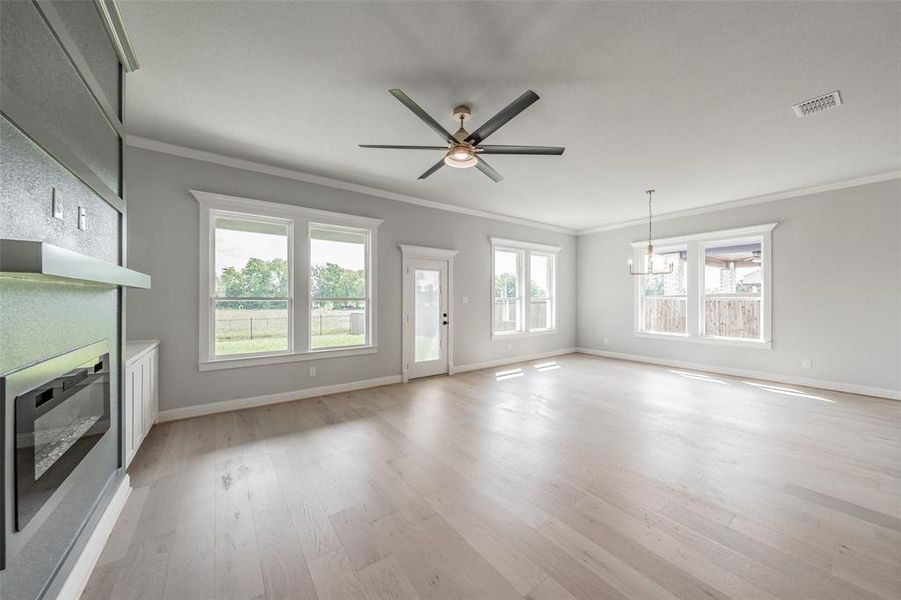 Living room overlooks the serene backyard backing up to green space overlooking horse pastures.