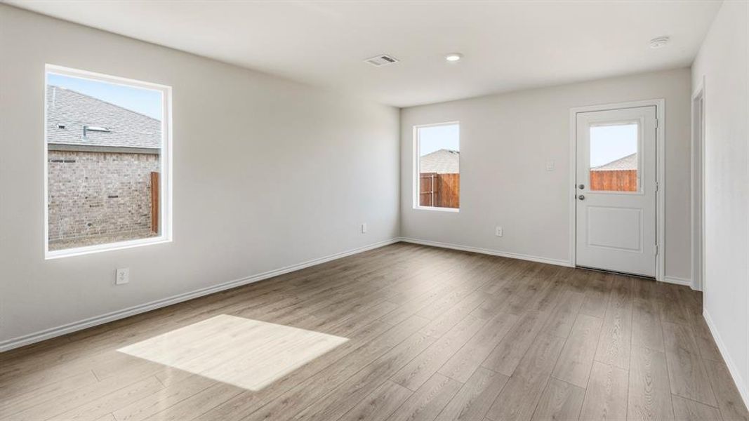 Spare room featuring baseboards and light wood-style floors