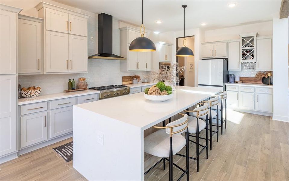 CUSTOM modern hood vent, Carrera QUARTZ countertops with a WATERFALL edge, and crushed black GRANITE farmhouse sink