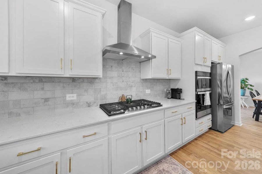 Kitchen with Gas Cooktop, Hood, Wall Oven and Microwave