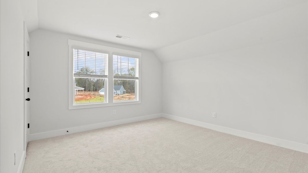 Highly functional bedroom with large windows, carpeted flooring, and tasteful finishes throughout Highly functional bedroom with large windows, carpeted flooring, and tasteful finishes throughout