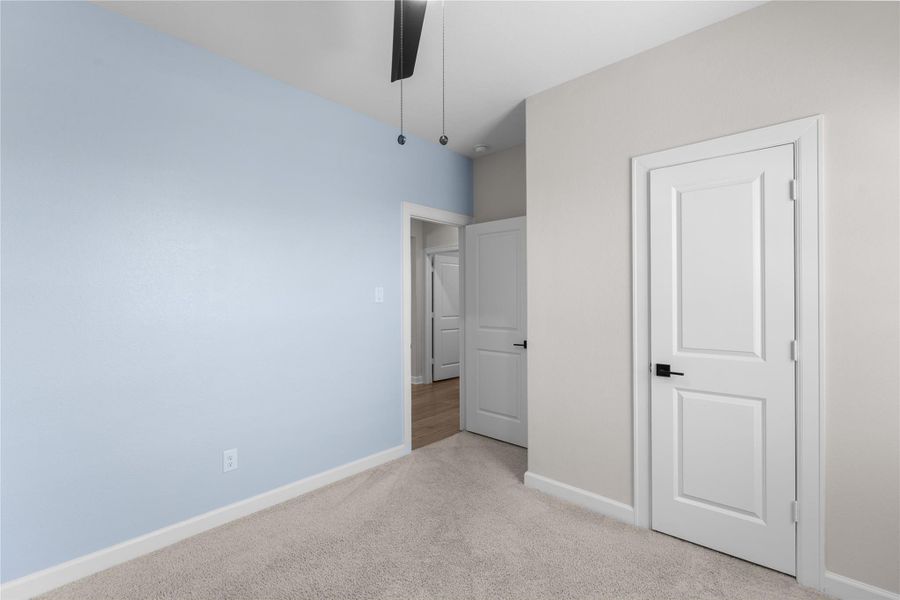 Additional secondary bedroom with soft carpeting, ceiling fan, and neutral finishes, offering a comfortable space for family, guests, or a home office Additional secondary bedroom with soft carpeting, ceiling fan, and neutral finishes, offering a comfortable space for family, guests, or a home office