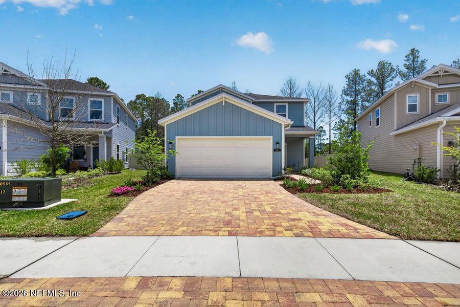Front exterior of a new home in St Augustine Lakes, St. Augustine, FL, highlighting curb appeal (Image 2).
