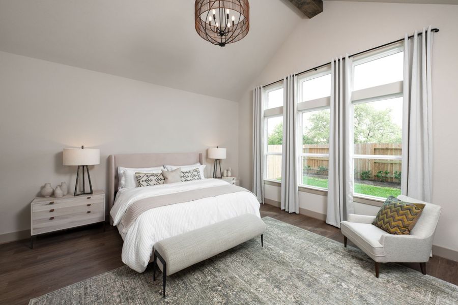 Primary bedroom with vaulted ceiling