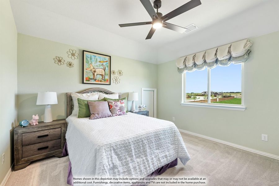 Bedroom with light green walls, ceiling fan, carpeted floor, and a window with a view outside.