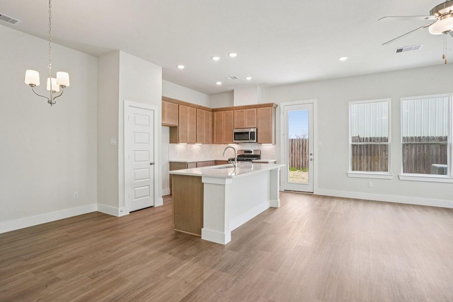 The open concept kitchen and family area create an inviting space for entertaining loved ones or finding solace after a busy day.