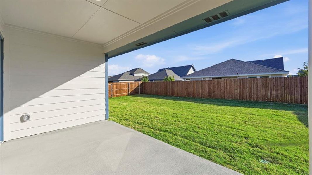 Fenced backyard featuring a patio area Fenced backyard featuring a patio area