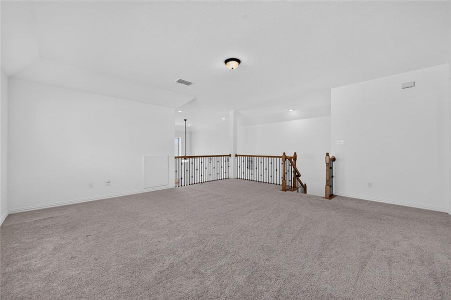 A spacious carpeted loft offers versatile living space overlooking the staircase. A spacious carpeted loft offers versatile living space overlooking the staircase.
