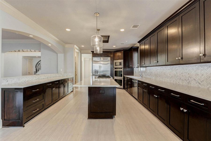 WOOD CABINETRY, QUARTZ COUNTERS, OPEN TO LIVING.  WALK-IN PANTRY, DIRECT ACCESS TO DINING ROOM.
