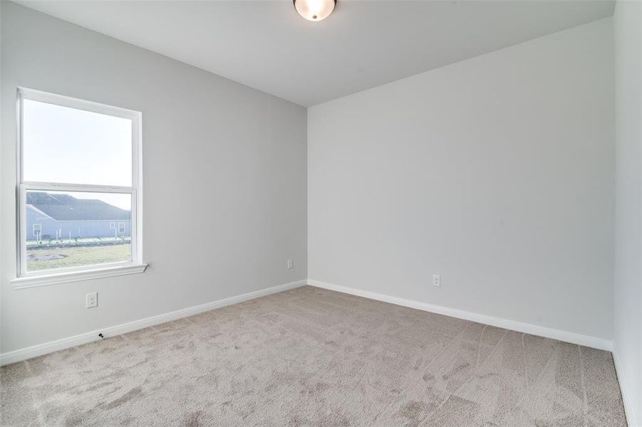 Empty room featuring light carpet