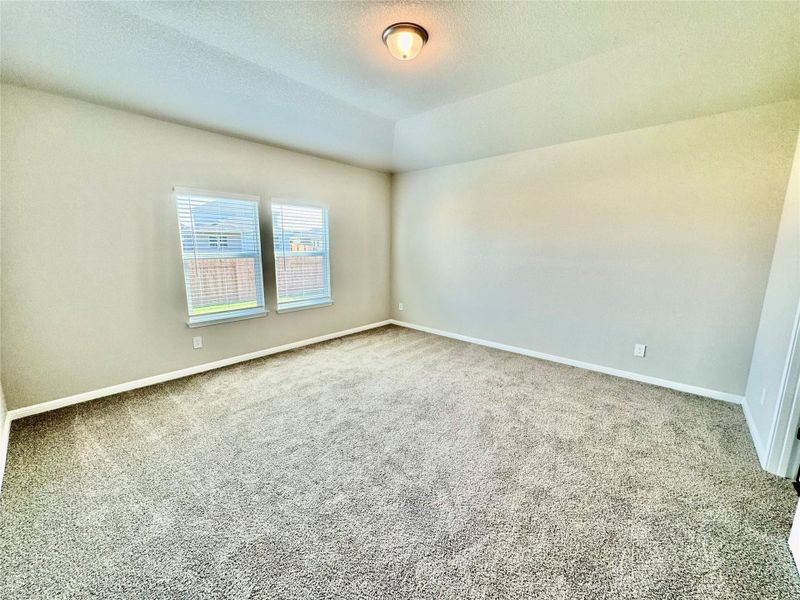 Empty room featuring carpet flooring and a textured ceiling Empty room featuring carpet flooring and a textured ceiling