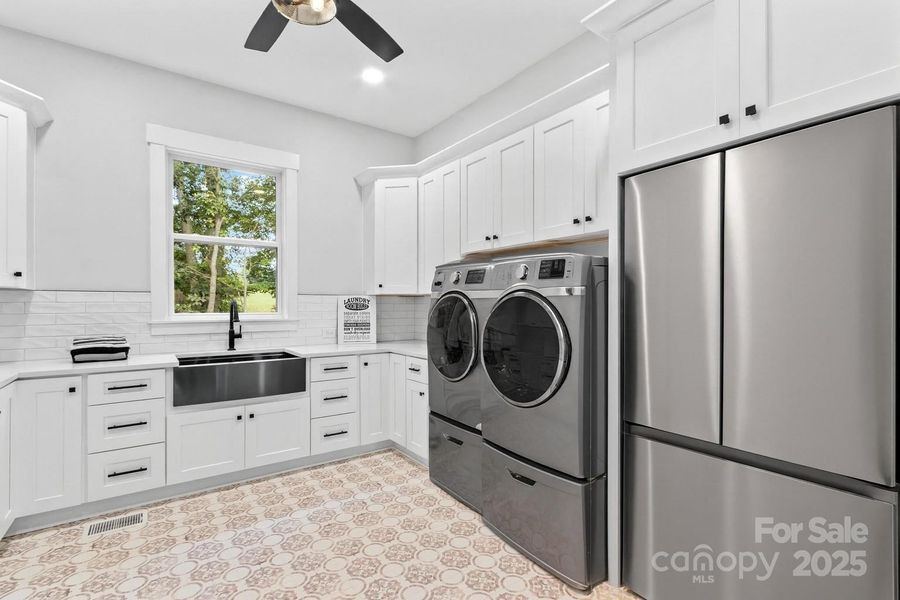 Laundry room so large it takes two photos to show. The appliances in here are virtually staged.