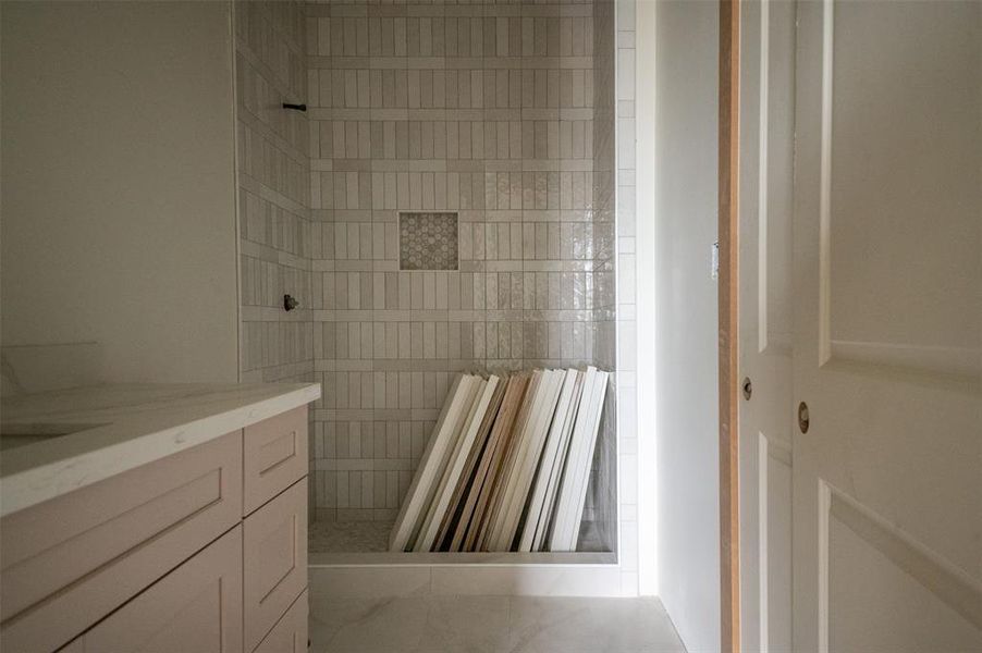 Floor to ceiling tile in every bathroom. Custom cabinets throughout.