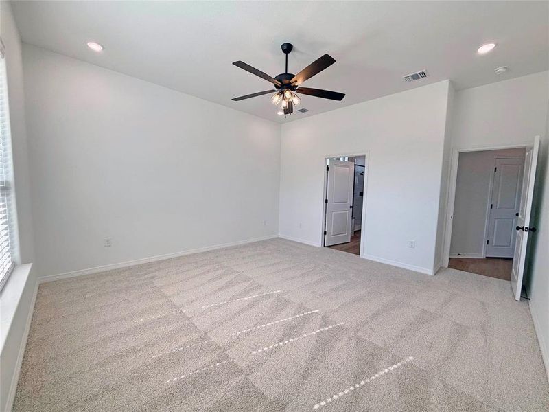 Unfurnished bedroom featuring recessed lighting, light carpet, and a ceiling fan
