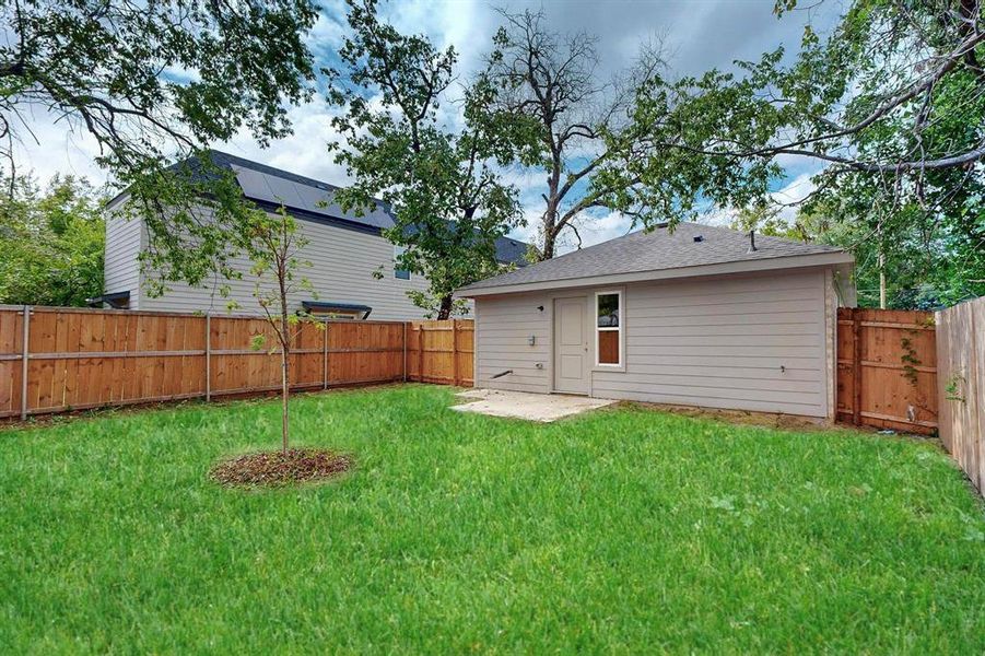 Back of property with a patio and a yard