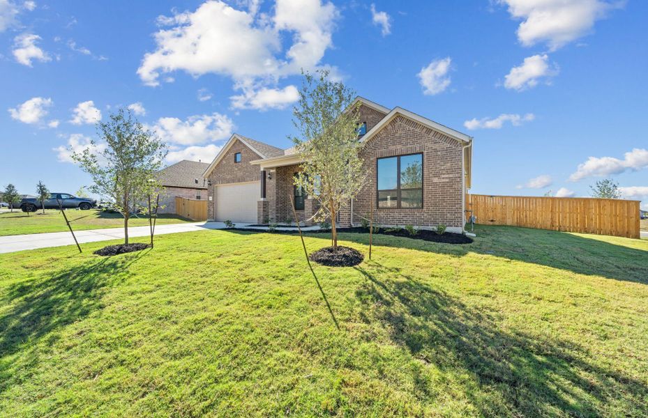 Front exterior of a new home in 6 Creeks, Kyle, TX, highlighting curb appeal (Image 24).