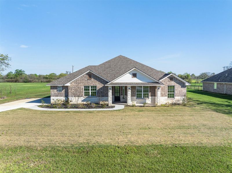 Front exterior of a new home in , Iola, TX, highlighting curb appeal (Image 22).